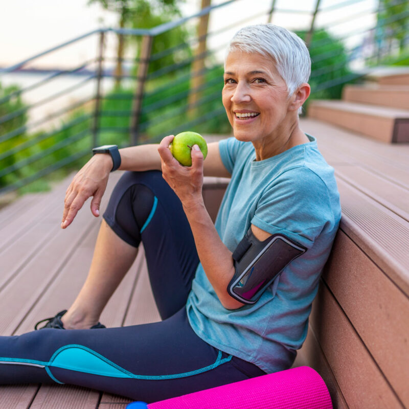 woman eating an apple after a workout