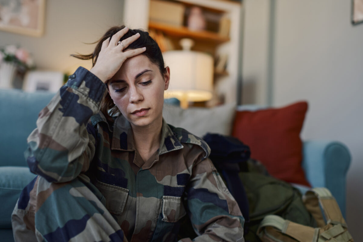 Depressed Female Soldier Suffering With PTSD